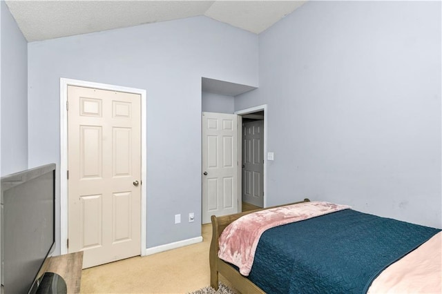 bedroom featuring lofted ceiling and carpet flooring