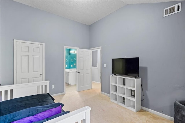 carpeted bedroom featuring connected bathroom, high vaulted ceiling, and a textured ceiling