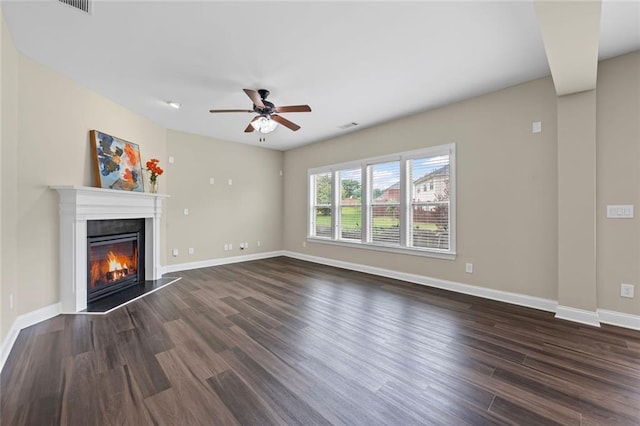 29 Lankford Rd, Tucker, GA 30084 - unfurnished living room with wood finished floors, ceiling fan, a glass covered fireplace, and baseboards