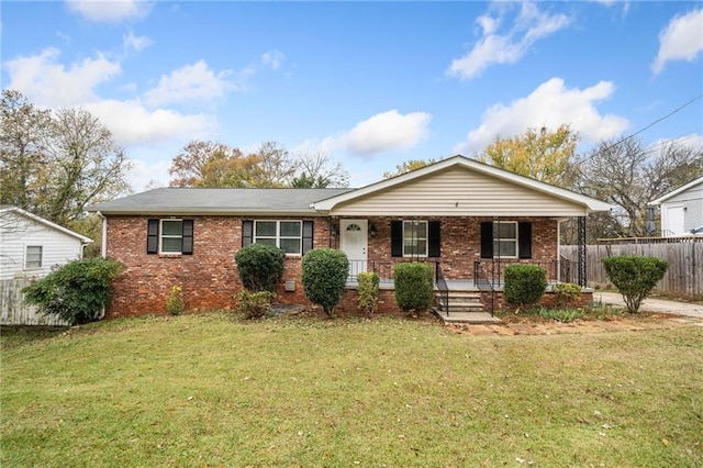 ranch-style home with a front yard, fence, a porch, and brick siding