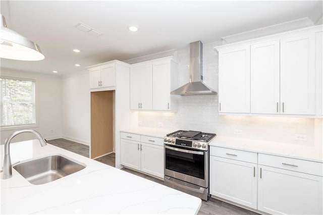 711 Dodd Ln N Unit 166, Buford, GA 30518 - kitchen with gas stove, wall chimney range hood, a sink, white cabinetry, and decorative backsplash