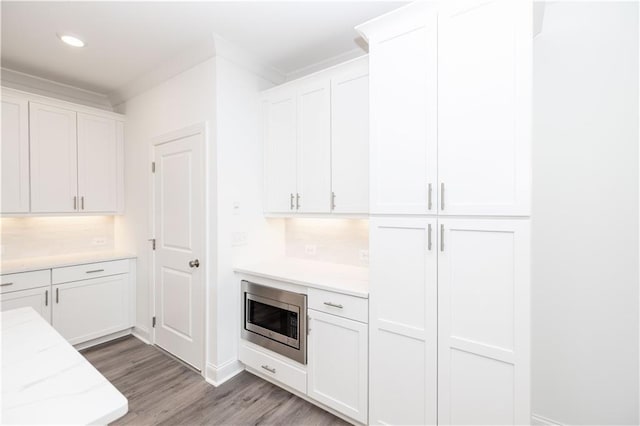 711 Dodd Ln N Unit 166, Buford, GA 30518 - kitchen featuring stainless steel microwave, white cabinetry, light wood-style flooring, and recessed lighting
