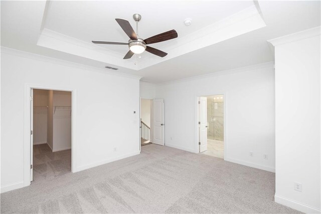 711 Dodd Ln N Unit 166, Buford, GA 30518 - unfurnished bedroom with a tray ceiling, crown molding, carpet flooring, a spacious closet, and a closet