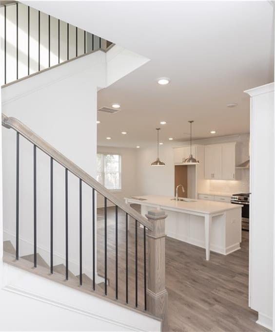 711 Dodd Ln N Unit 166, Buford, GA 30518 - staircase featuring wood finished floors and recessed lighting