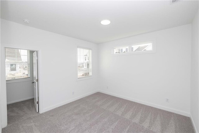 711 Dodd Ln N Unit 166, Buford, GA 30518 - carpeted empty room with plenty of natural light and baseboards