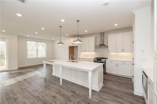 711 Dodd Ln N Unit 166, Buford, GA 30518 - kitchen with wall chimney range hood, stainless steel gas range, a sink, backsplash, and dark wood-style flooring