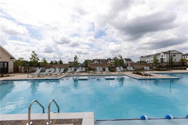 711 Dodd Ln N Unit 166, Buford, GA 30518 - community pool with a patio area and fence