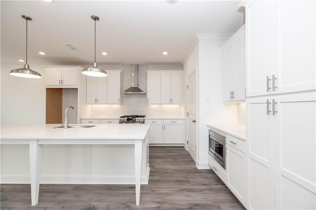 711 Dodd Ln N Unit 166, Buford, GA 30518 - kitchen featuring a sink, wall chimney exhaust hood, stainless steel appliances, decorative backsplash, and white cabinets