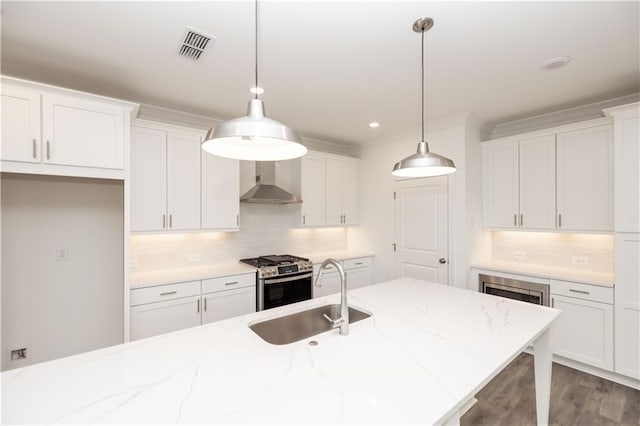 711 Dodd Ln N Unit 166, Buford, GA 30518 - kitchen featuring a sink, wall chimney range hood, stainless steel gas stove, white cabinets, and recessed lighting
