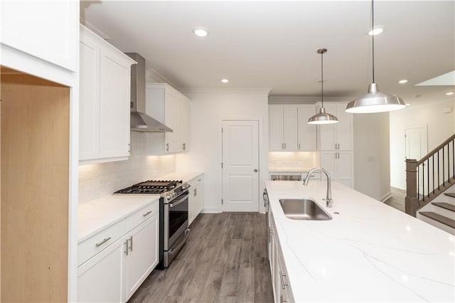 711 Dodd Ln N Unit 166, Buford, GA 30518 - kitchen with gas stove, wall chimney exhaust hood, a sink, tasteful backsplash, and recessed lighting