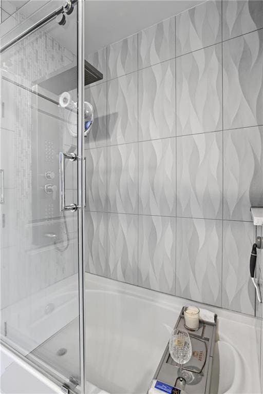 bathroom with shower / bath combination with glass door