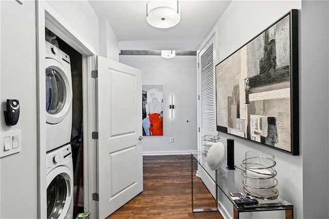 laundry area featuring dark hardwood / wood-style floors and stacked washer / dryer