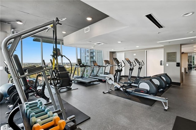 gym with a wall of windows