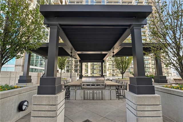 view of patio featuring a gazebo, area for grilling, exterior kitchen, and exterior bar