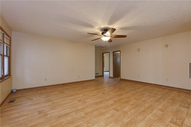 empty room featuring light hardwood / wood-style flooring and ceiling fan