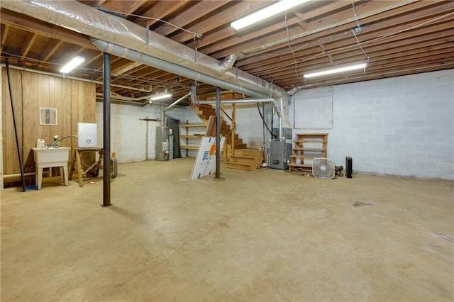 basement with gas water heater, sink, and heating unit