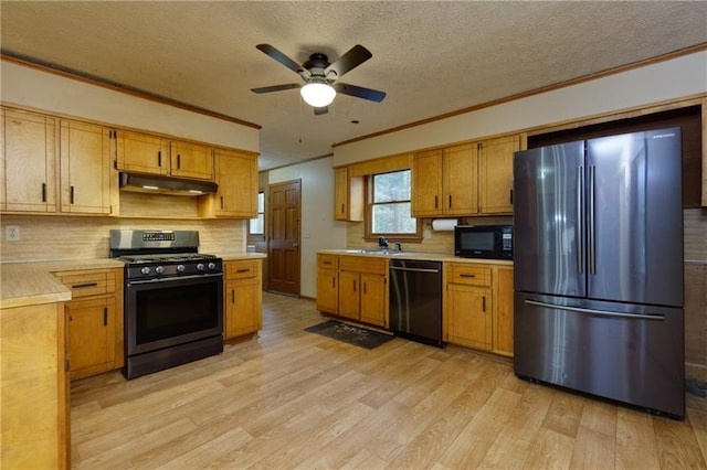 kitchen with black appliances, crown molding, ceiling fan, light wood-type flooring, and a textured ceiling