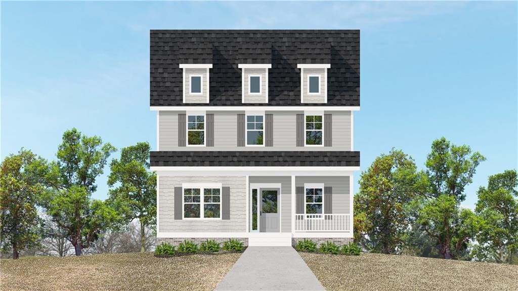 view of front of property with covered porch and a shingled roof