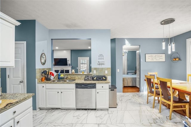 kitchen featuring light stone counters, a sink, white cabinets, dishwasher, and marble finish floor