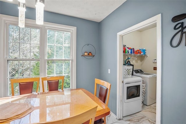 dining area with marble finish floor and a textured ceiling