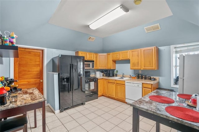 kitchen with visible vents, lofted ceiling, black appliances, and light countertops