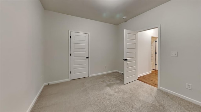 unfurnished bedroom featuring light carpet