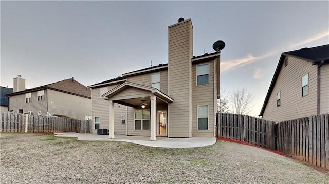 back of house featuring a yard, a patio area, and central AC