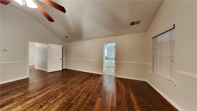 unfurnished bedroom with ceiling fan, lofted ceiling, dark hardwood / wood-style flooring, and ensuite bath