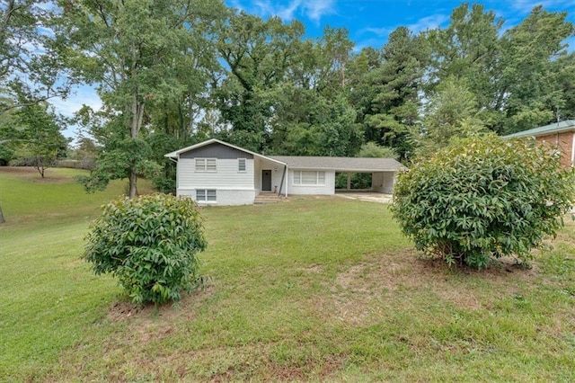 rear view of house featuring a lawn, a carport, and entry steps