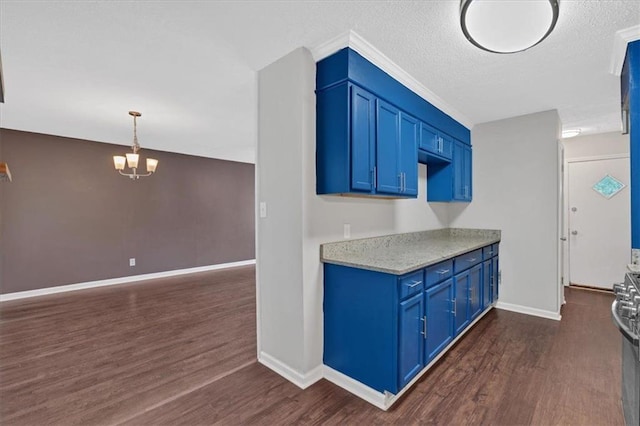 kitchen with light countertops, dark wood-style flooring, a chandelier, and blue cabinets