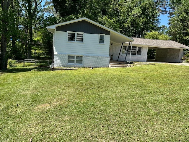 split level home featuring fence, a carport, a front lawn, and brick siding