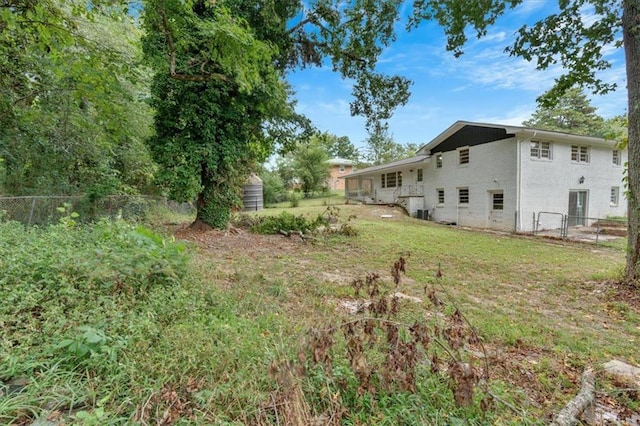 view of yard with fence, an outbuilding, and a storage unit