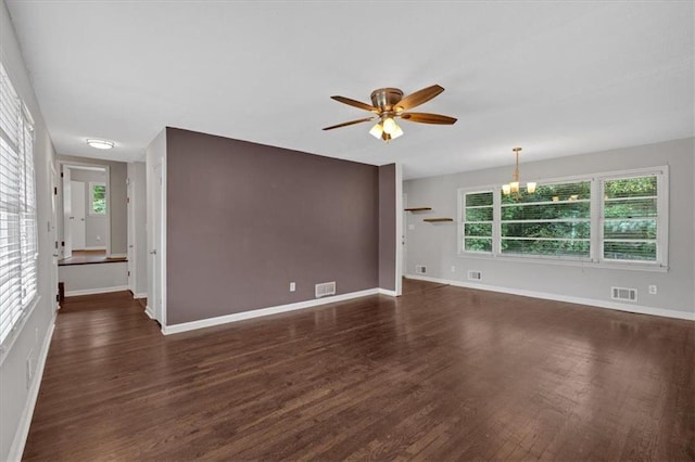 unfurnished living room featuring ceiling fan with notable chandelier, wood finished floors, and visible vents