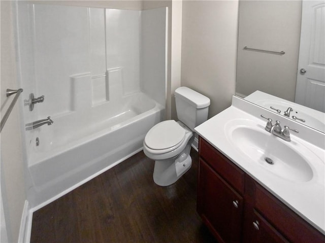 full bathroom with hardwood / wood-style floors, vanity,  shower combination, and toilet