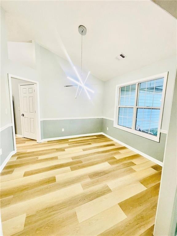 7675 Lanier View Rdg, Cumming, GA 30041 - empty room featuring wood finished floors, baseboards, and lofted ceiling