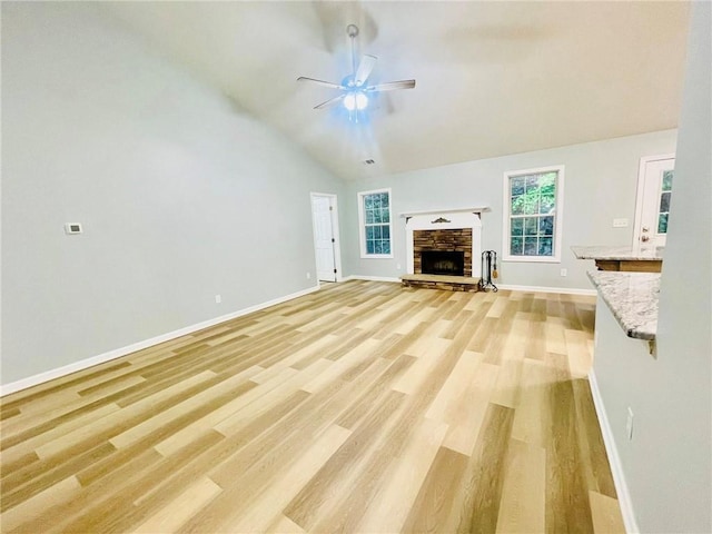 7675 Lanier View Rdg, Cumming, GA 30041 - unfurnished living room with a ceiling fan, light wood-style flooring, plenty of natural light, vaulted ceiling, and baseboards