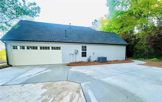 7675 Lanier View Rdg, Cumming, GA 30041 - rear view of property featuring driveway, a shingled roof, and central air condition unit