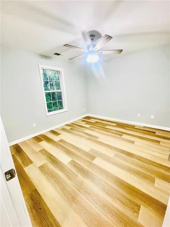 7675 Lanier View Rdg, Cumming, GA 30041 - spare room featuring wood finished floors, baseboards, and a ceiling fan