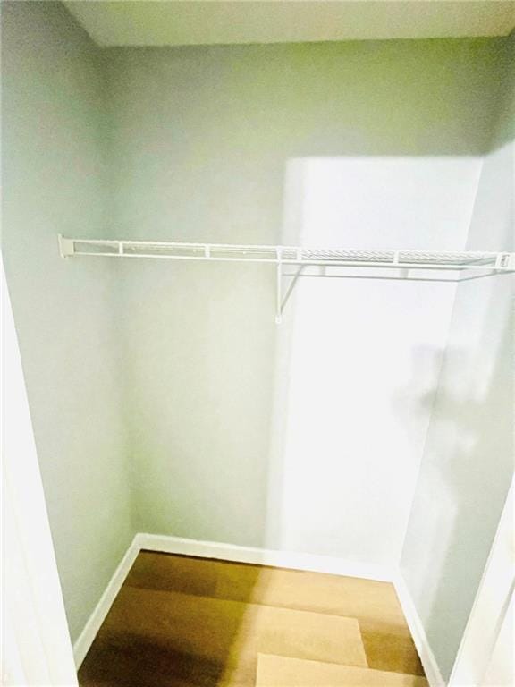 7675 Lanier View Rdg, Cumming, GA 30041 - walk in closet featuring wood finished floors