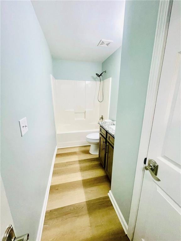 7675 Lanier View Rdg, Cumming, GA 30041 - bathroom with wood finished floors, vanity, toilet, shower / bath combination, and baseboards