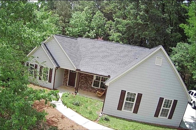 7675 Lanier View Rdg, Cumming, GA 30041 - view of front of property featuring a patio, a shingled roof, and stone siding