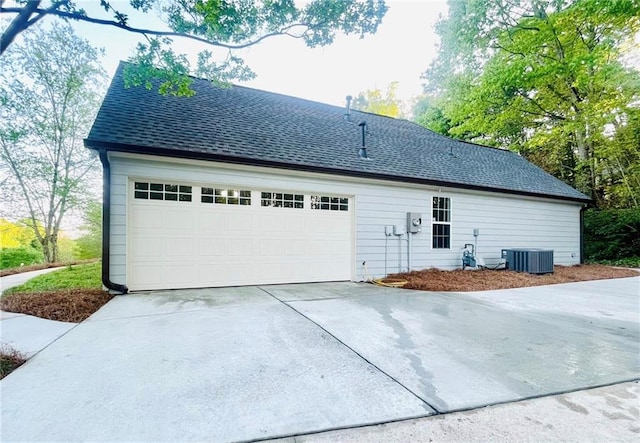 7675 Lanier View Rdg, Cumming, GA 30041 - view of home's exterior featuring central air condition unit, concrete driveway, and roof with shingles
