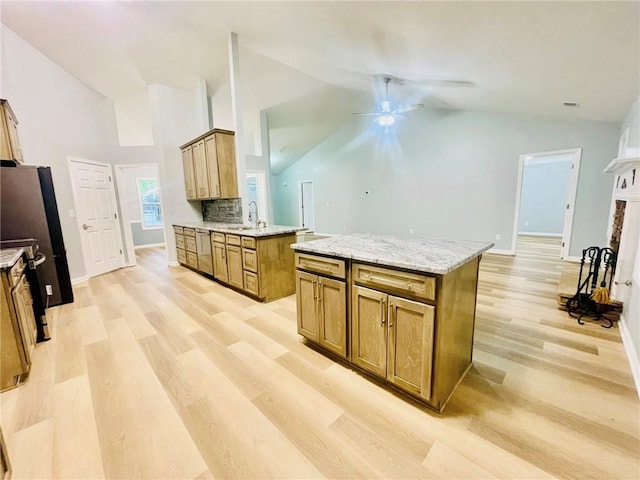 7675 Lanier View Rdg, Cumming, GA 30041 - kitchen with a ceiling fan, light wood-type flooring, tasteful backsplash, brown cabinetry, and baseboards