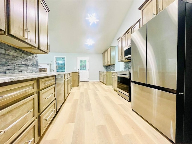 7675 Lanier View Rdg, Cumming, GA 30041 - kitchen with appliances with stainless steel finishes, light wood-type flooring, decorative backsplash, lofted ceiling, and a sink