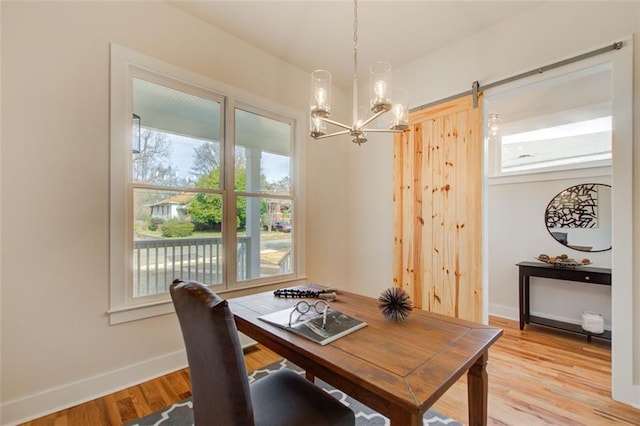 1240 Oakland Ter SW Unit B, Atlanta, GA 30310 - dining space with a barn door, a chandelier, light wood-style flooring, and a desk