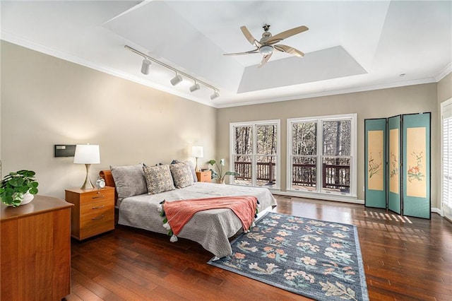 bedroom with ceiling fan, access to outside, ornamental molding, hardwood / wood-style floors, and a raised ceiling