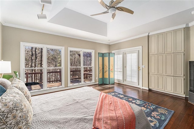 bedroom featuring dark wood finished floors, a ceiling fan, ornamental molding, access to outside, and a tray ceiling