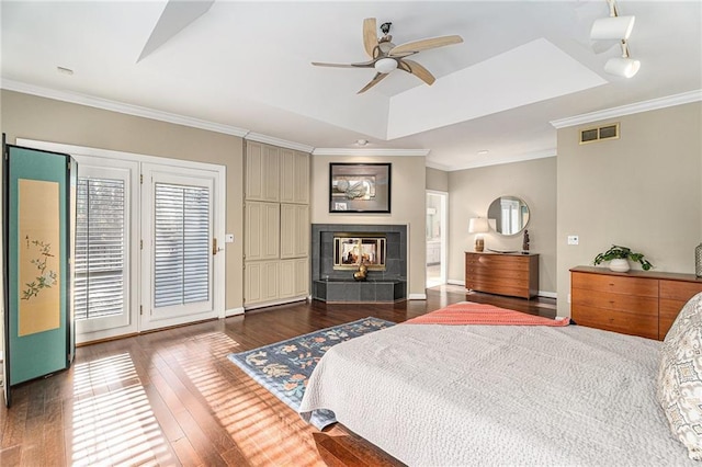 bedroom featuring wood-type flooring, visible vents, and crown molding