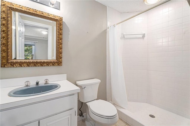 full bathroom with a stall shower, a textured ceiling, toilet, and vanity