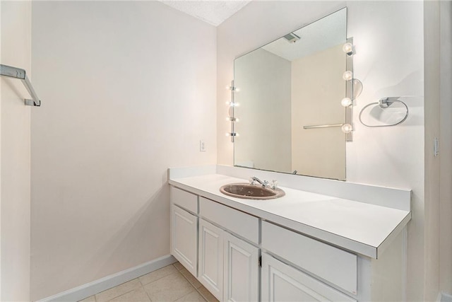 bathroom featuring vanity, baseboards, and tile patterned floors